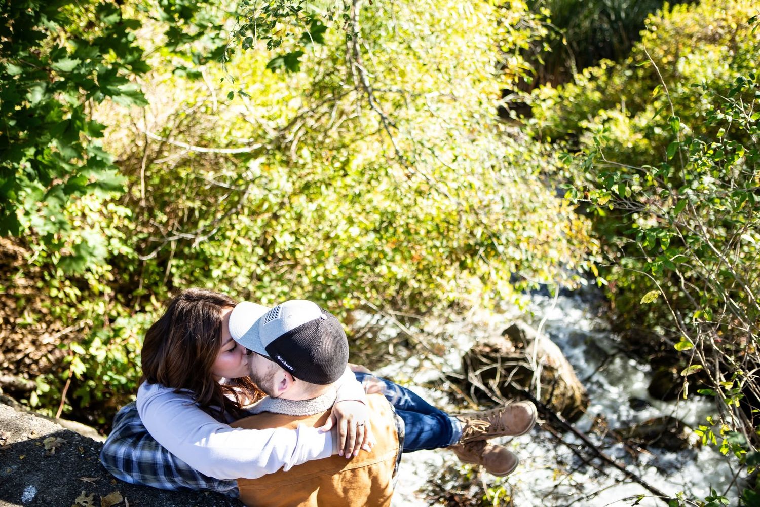 A sequence of photos showing a couple lying in grass under sunlit tree branches.