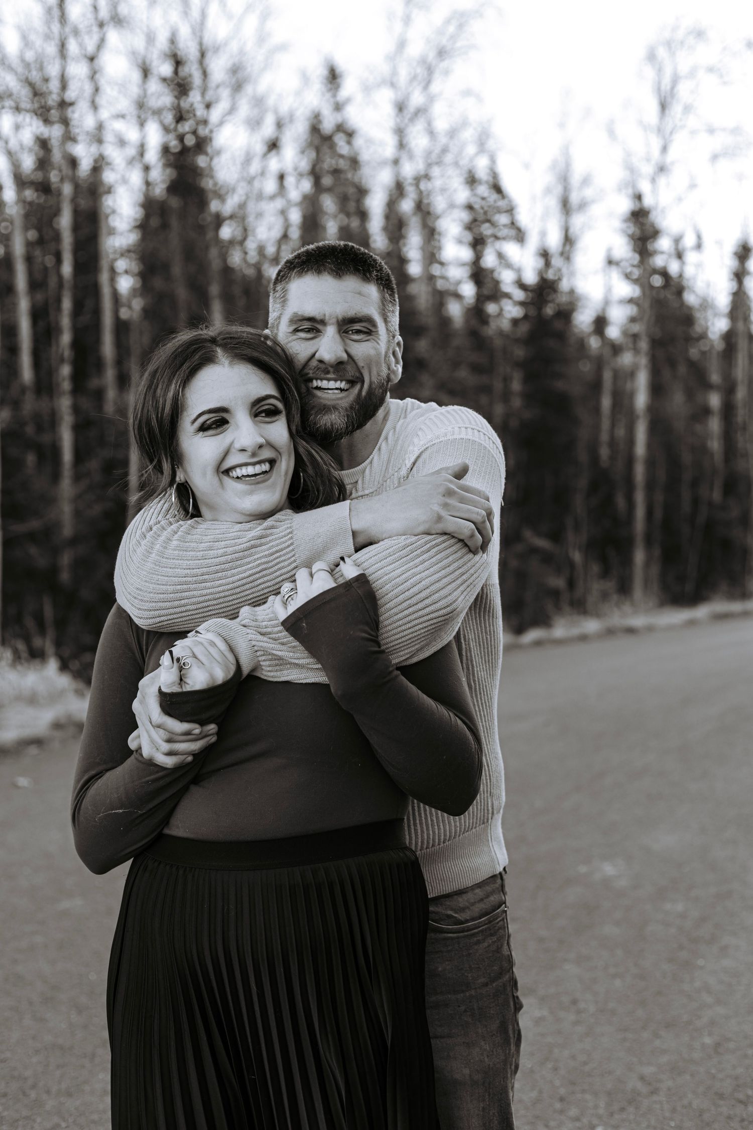 Black and white portrait of a couple embracing each other in an outdoor family session