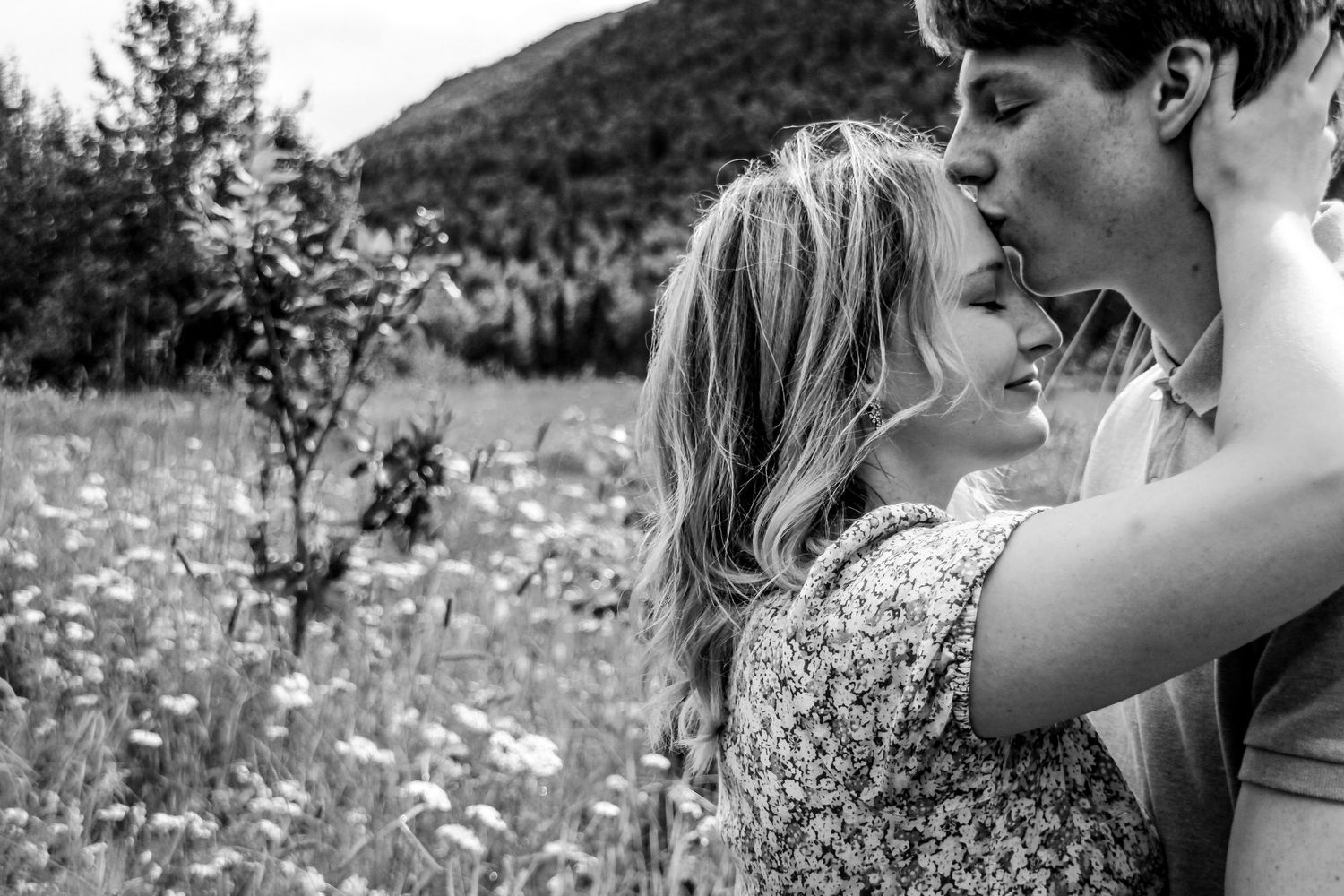 Sweet embrace of forehead kisses during a Couples session in Alaska