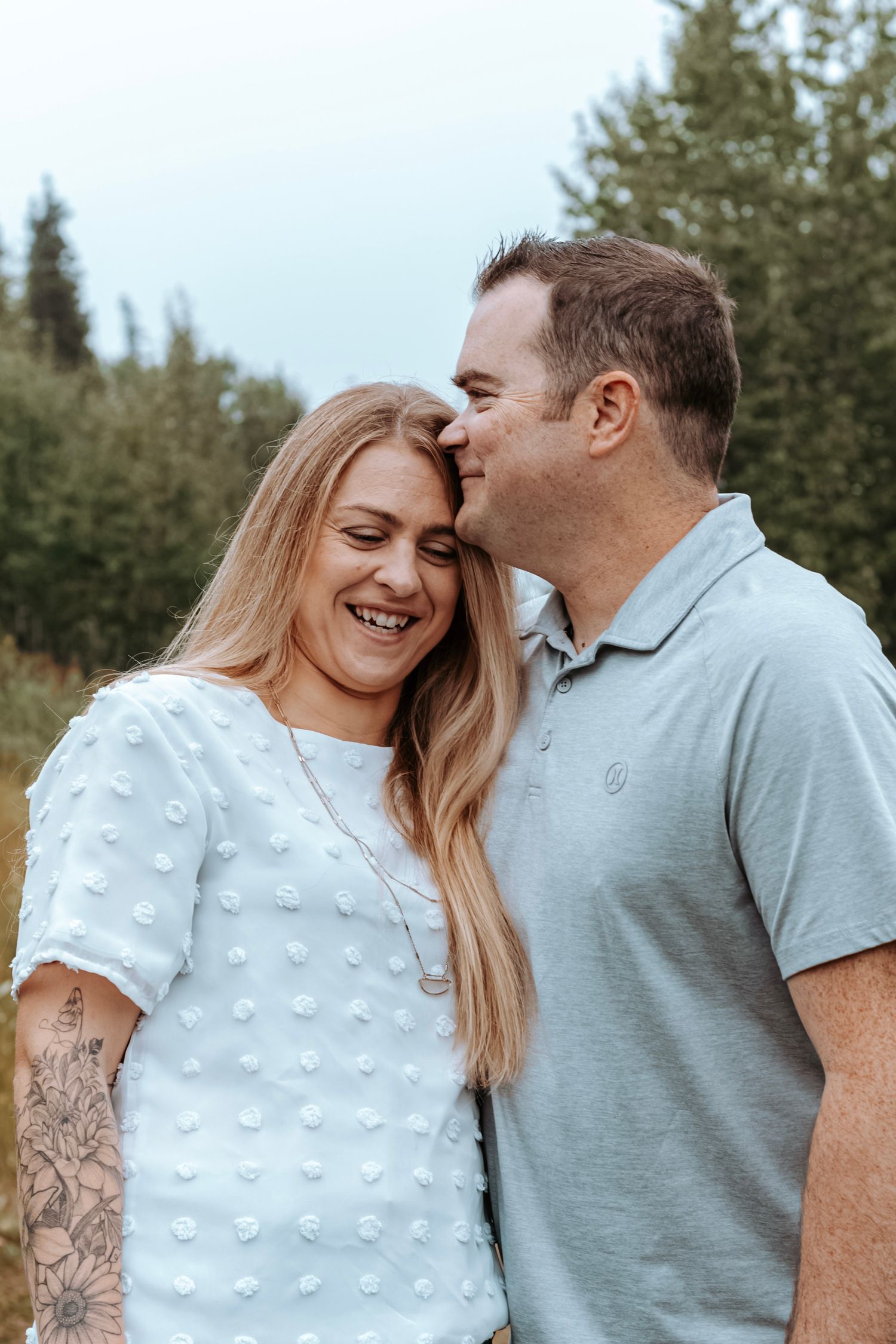 Couple sharing a quiet, loving moment outdoors during a natural lifestyle photography session.