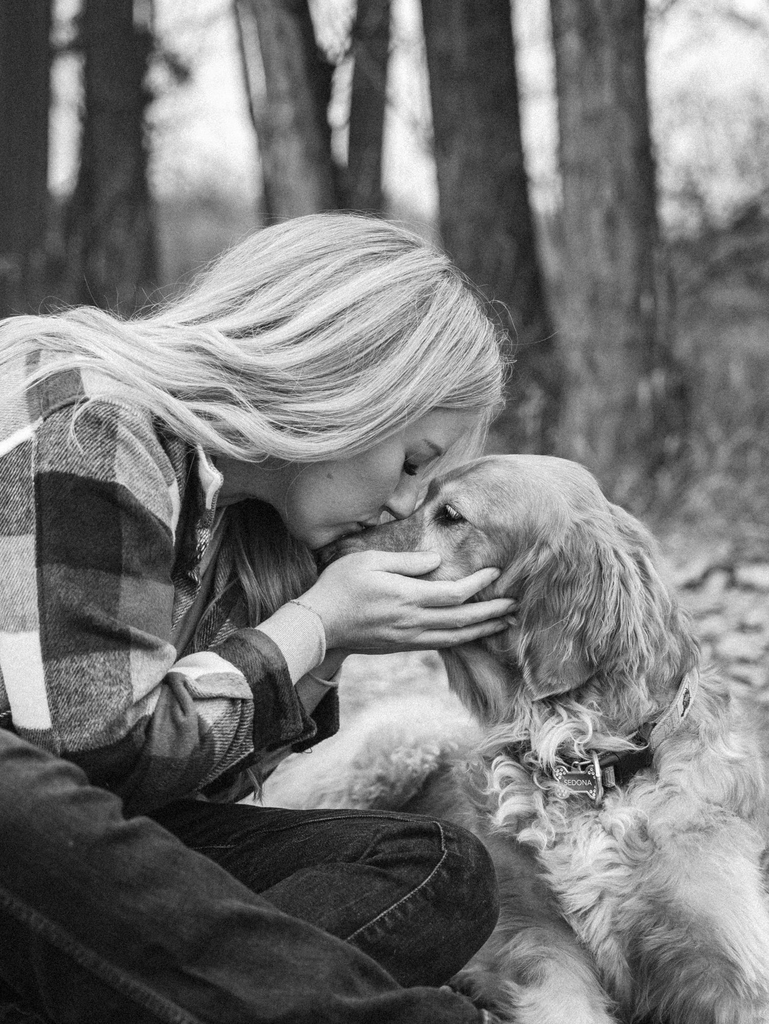 A tender moment captured in black and white as someone in a plaid shirt shares an intimate moment with their spaniel dog. Great  Falls, MT