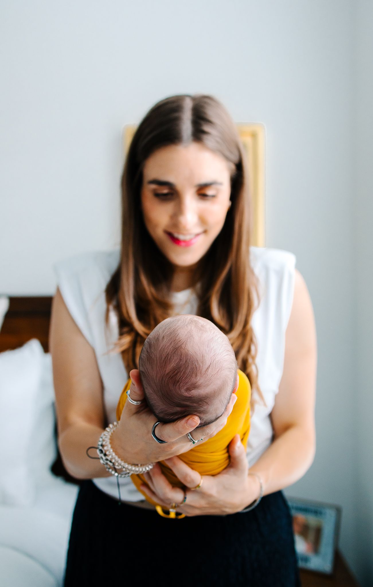 A tender moment between a mother and her newborn son showing how small his head is in her hand.