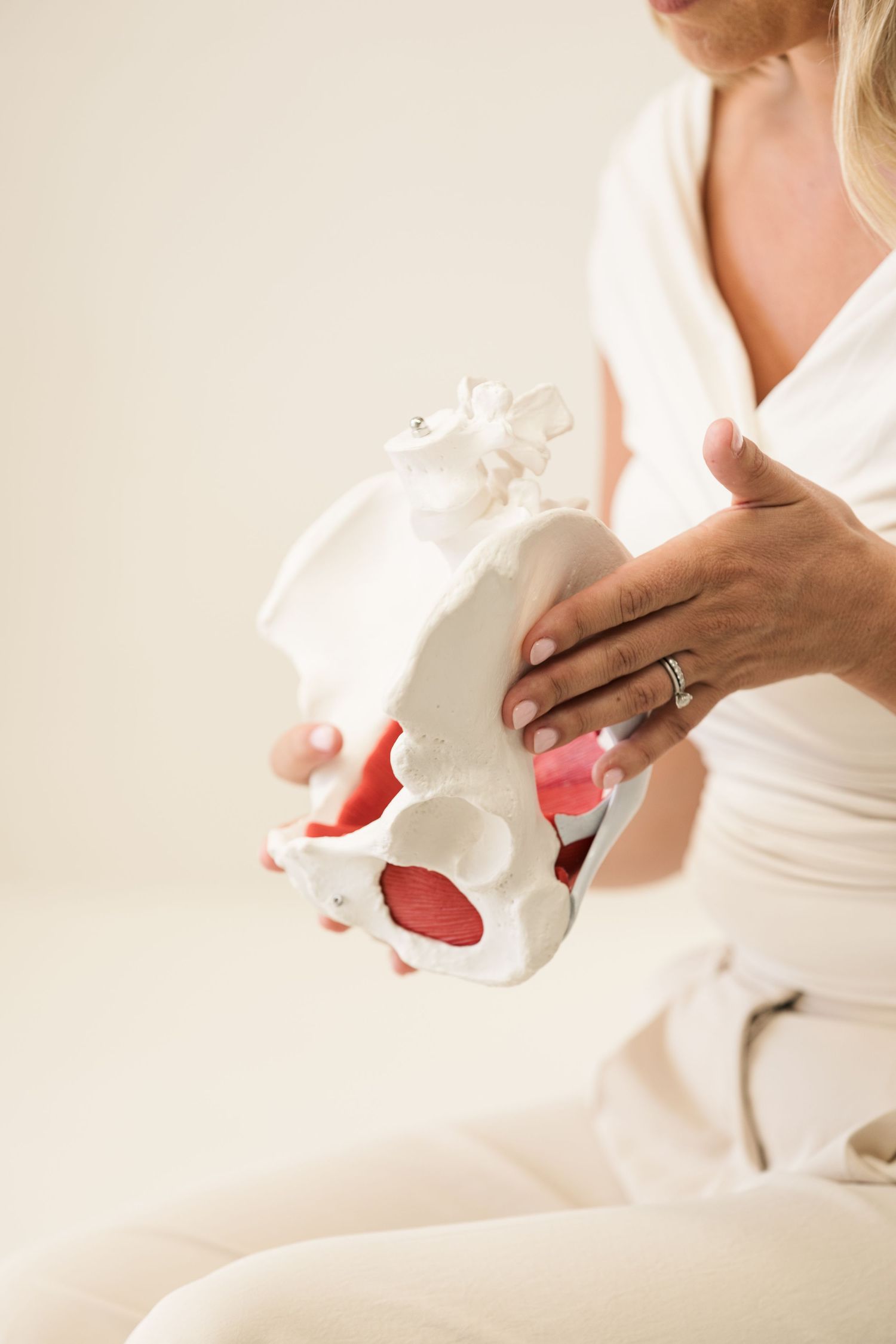 Close-up shots of hands holding white ceramic pieces against neutral background.
