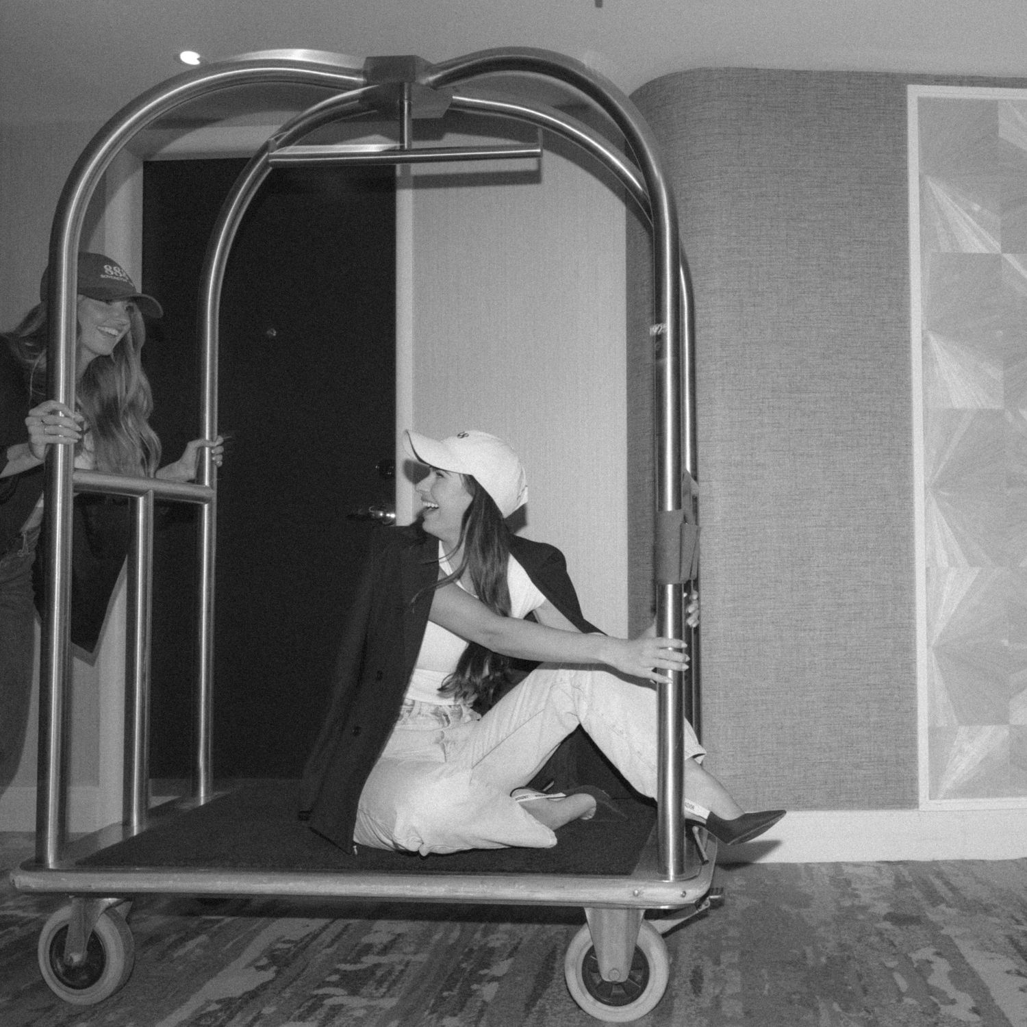 A black and white photo sequence showing a figure crawling through a curved metal tube or tunnel structure.