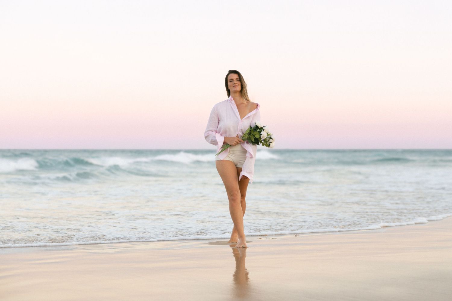 Series of ethereal beach scenes at sunset with figure walking along pristine shoreline in soft pink light.