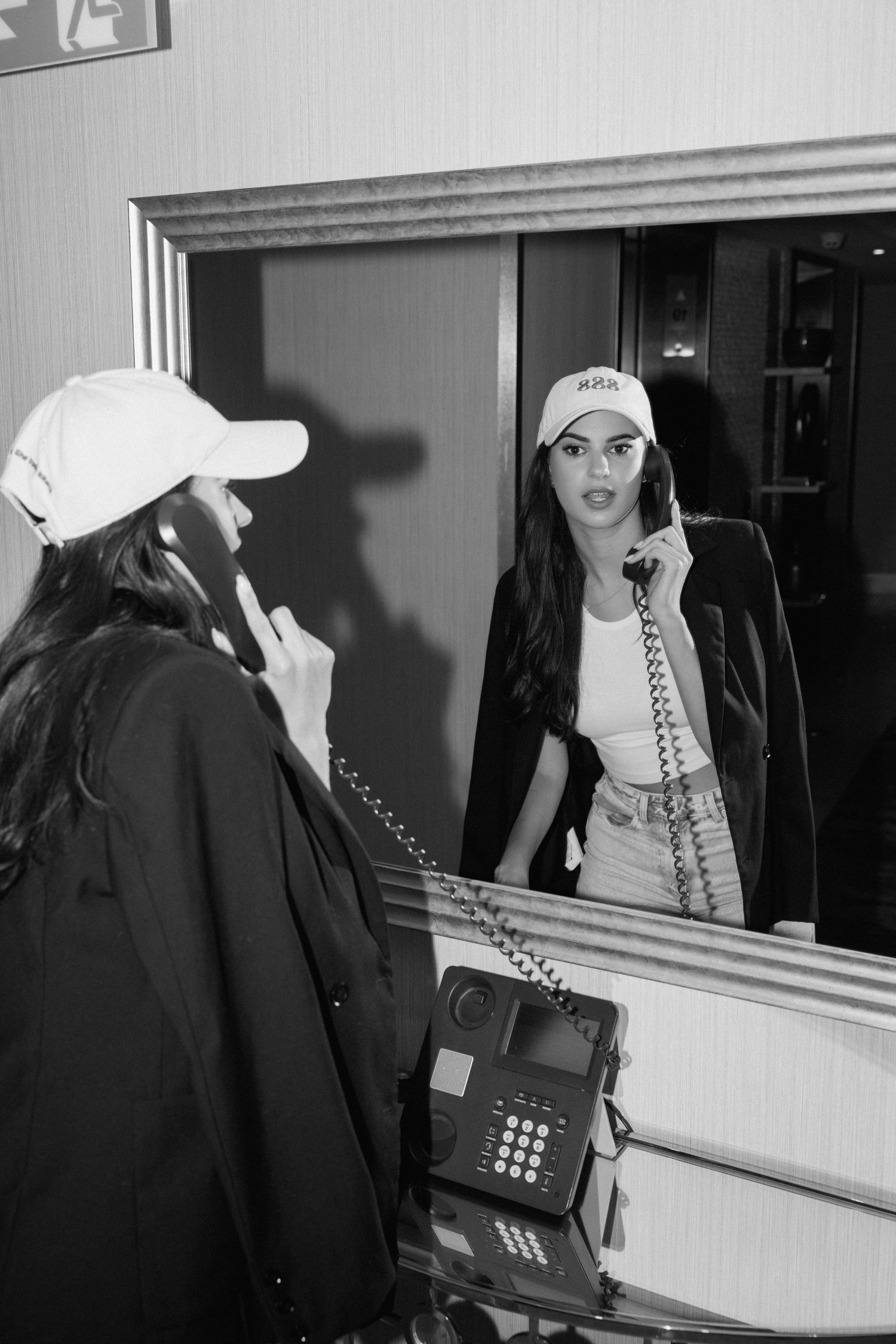 A series of black and white photos showing someone using a retro telephone against a wall.