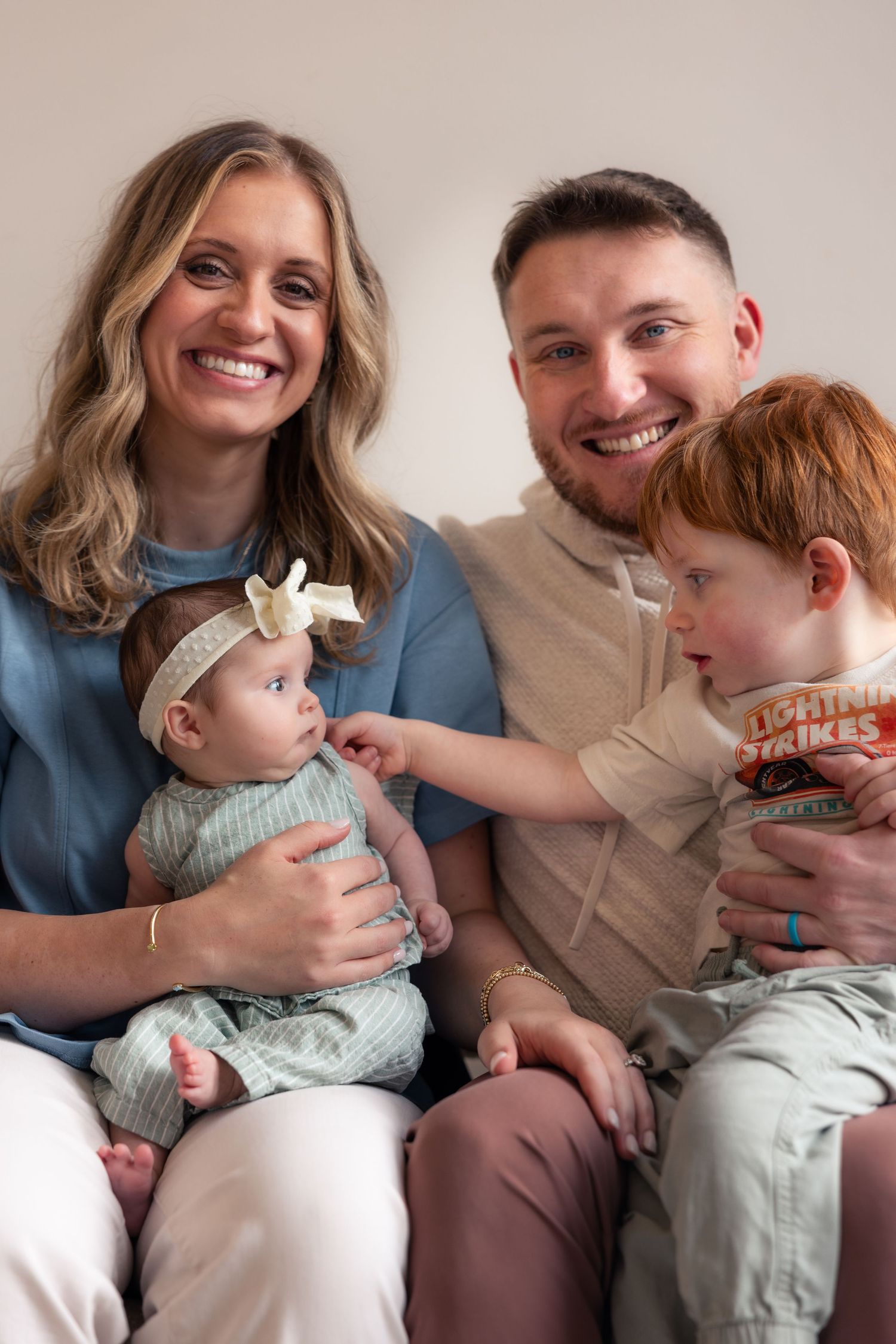 A series of candid family moments showing adults and baby sharing joyful laughter while sitting together.