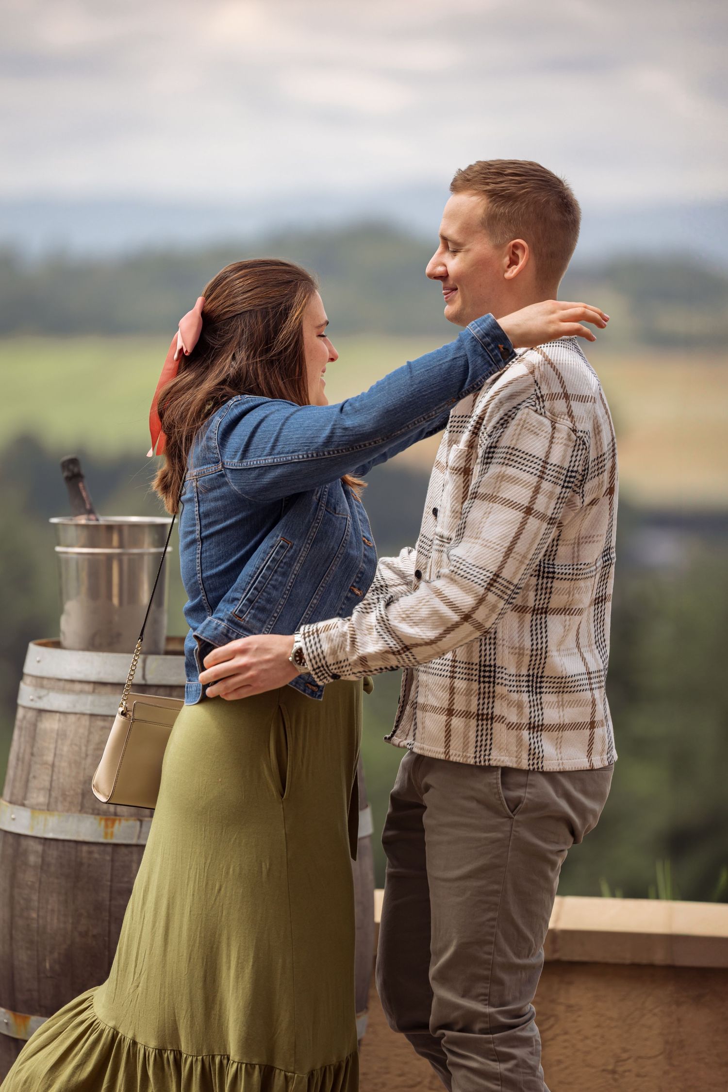 A romantic proposal sequence at a winery showing a surprise engagement unfolding with wine barrels and scenic views.