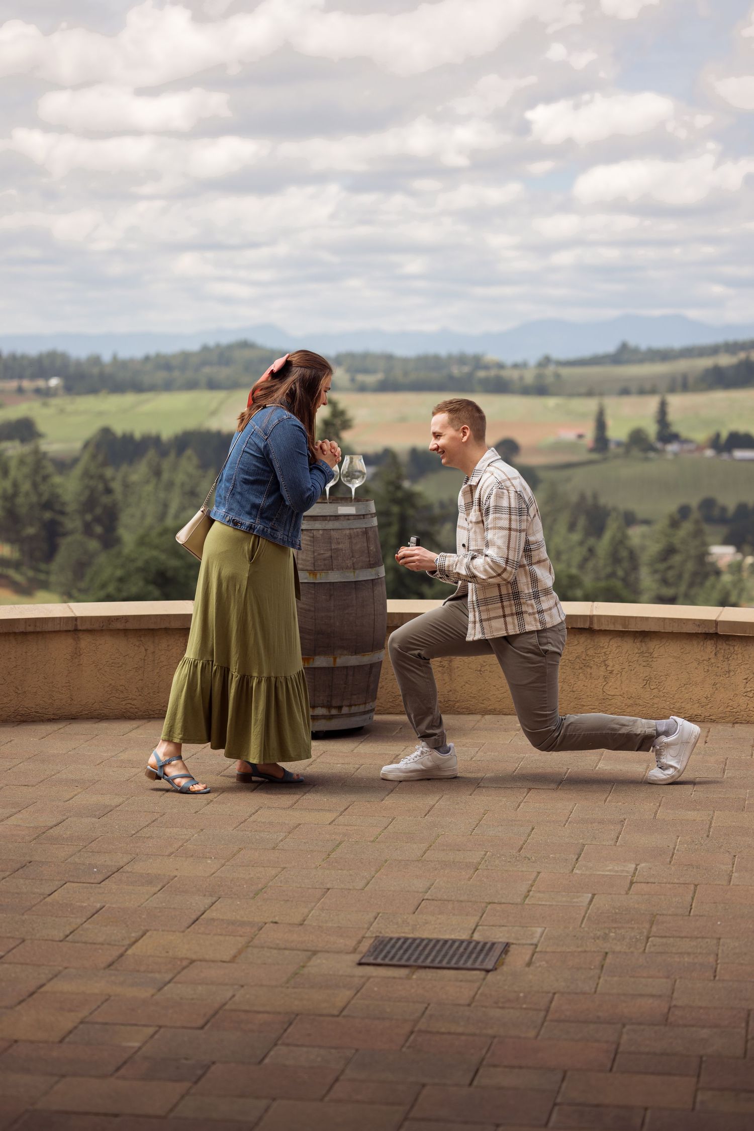 A series of images capturing a proposal moment on a scenic terrace with rolling hills in the background.