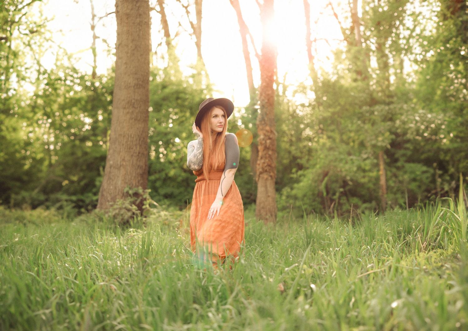 Family enjoying a golden sunset walk through a grassy meadow taken by Salem, Oregon family photographer.