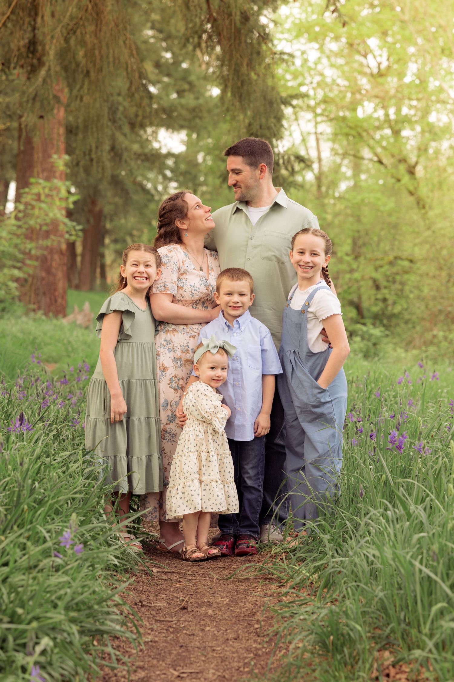 A playful family photo sequence on a wooded path during a photo session taken by Salem, Oregon family photographer.