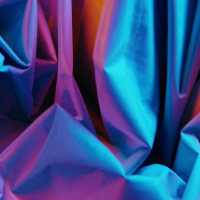 Neon geometric abstract pattern with wavy lines in purple, blue and black colors creates a vibrant digital art effect.