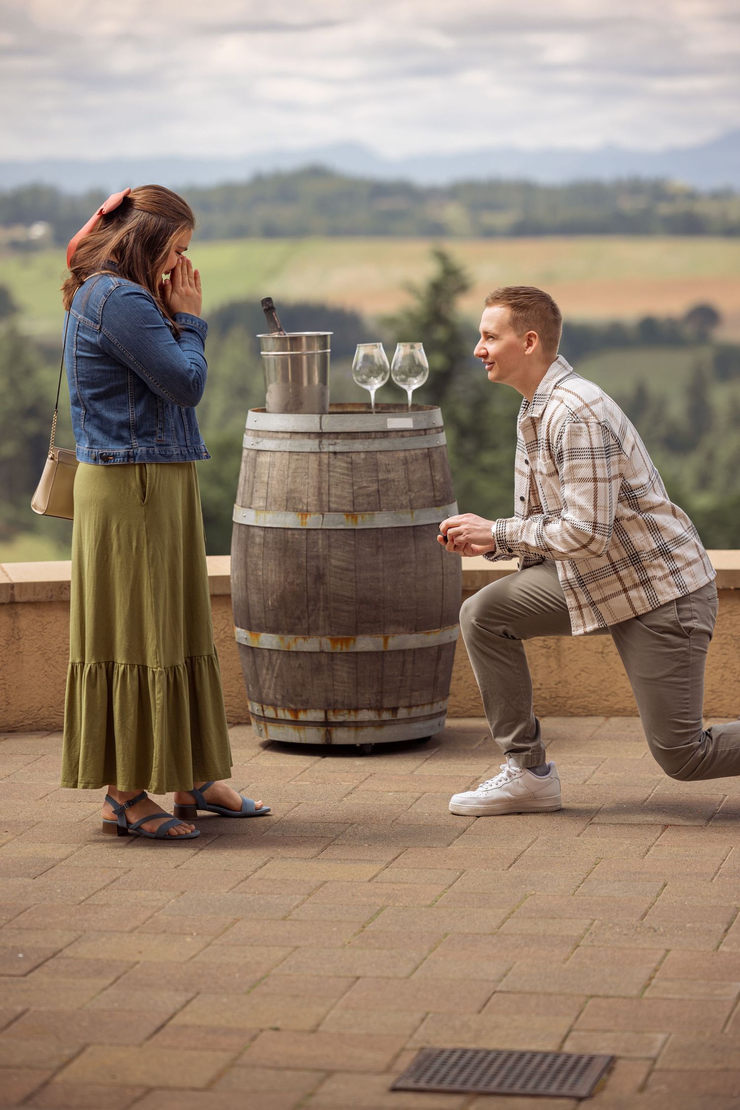 A sequence of photos showing a couple overlooking scenic wine country from a winery terrace with wine barrels.