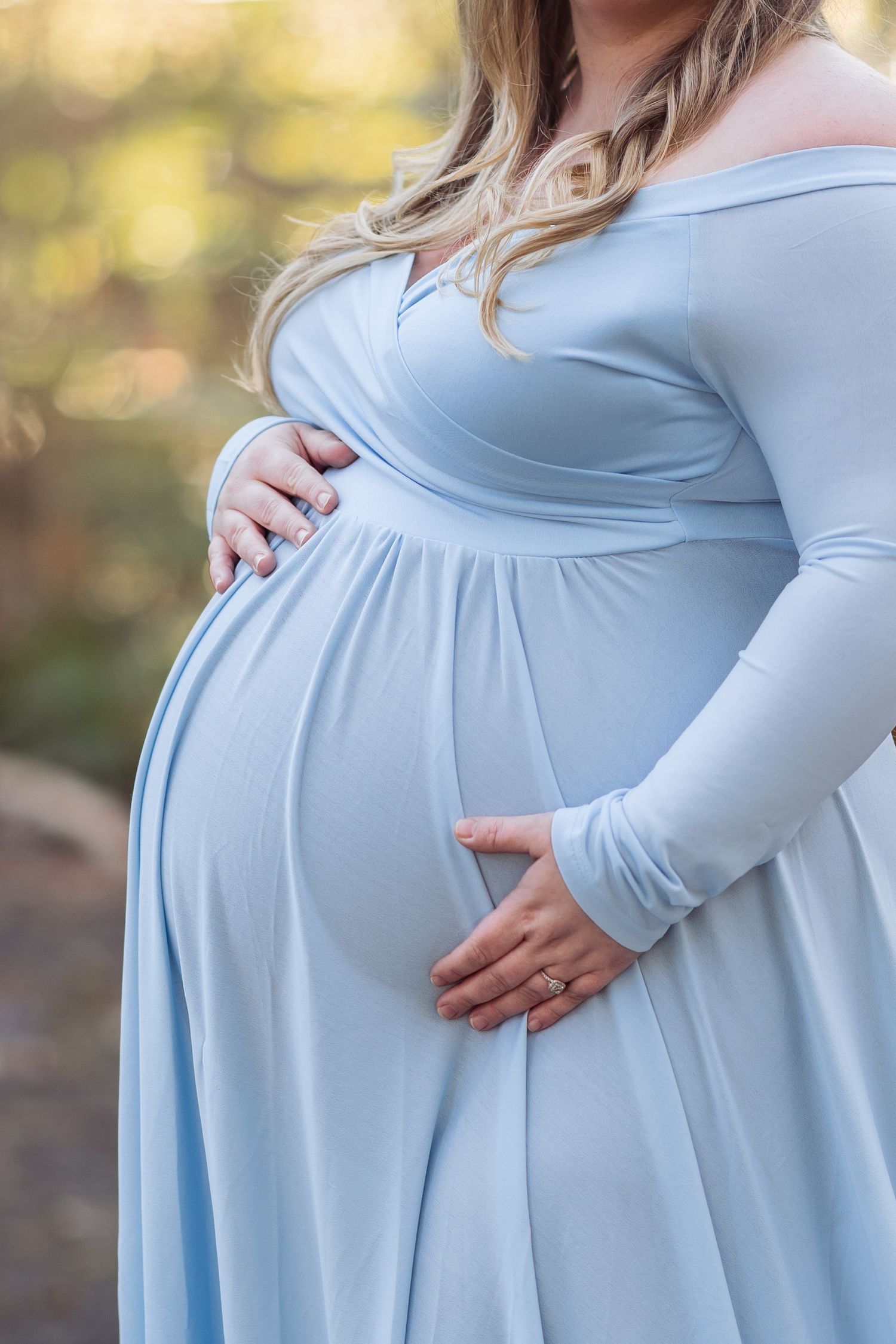 A light blue maternity dress shown from different angles highlighting the flowing fabric and baby bump silhouette.