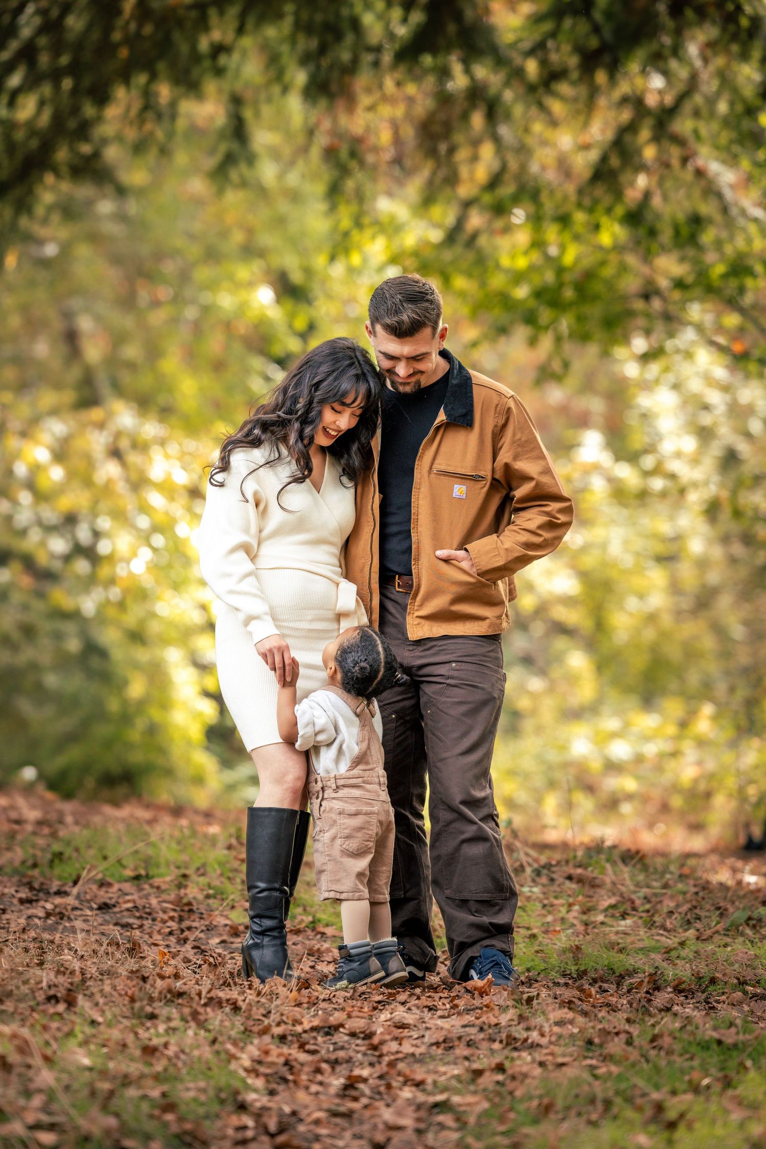 Family exploring and playing together on a trail covered in autumn leaves taken by Salem, Oregon family photographer.