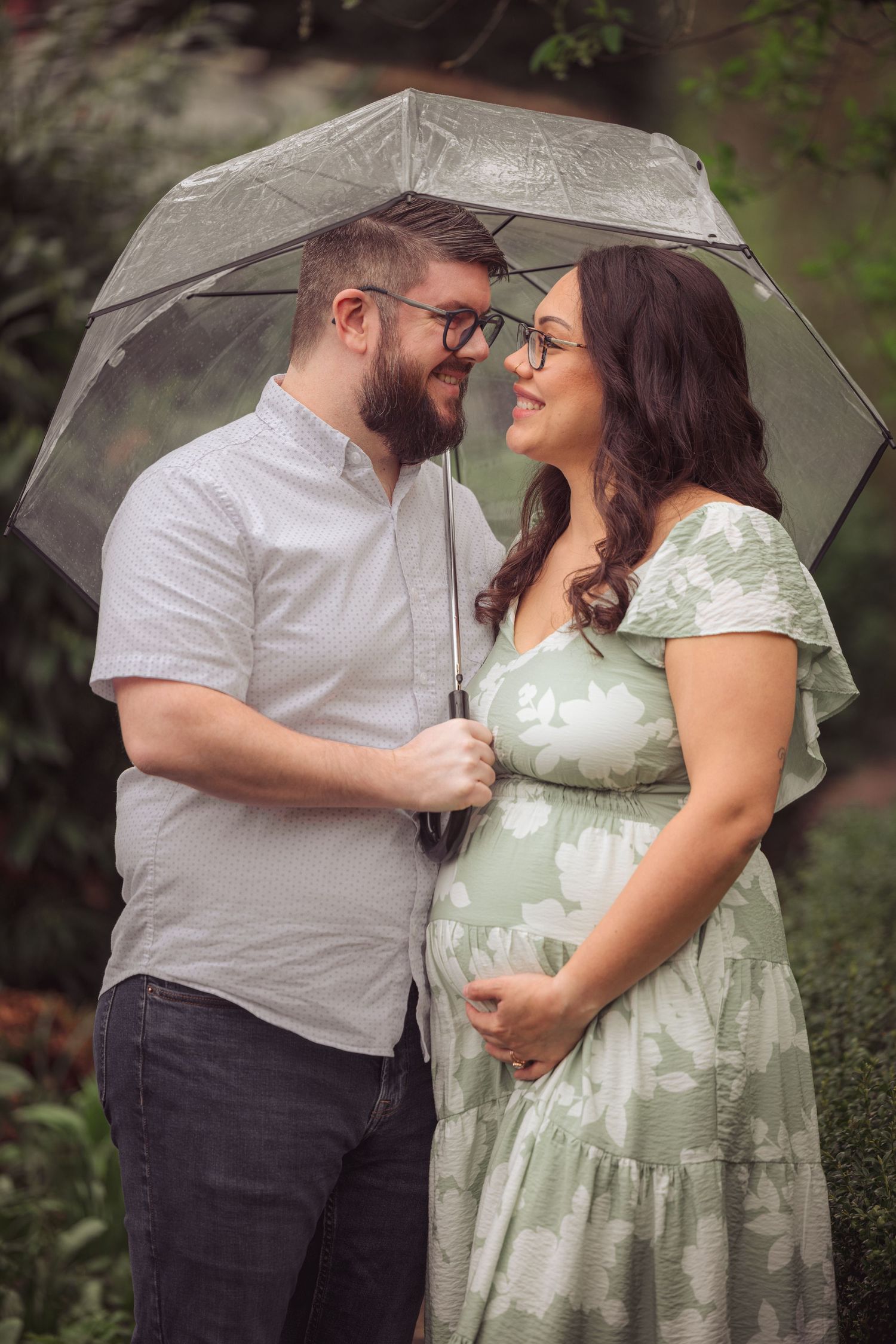 A romantic couple under a clear umbrella share intimate moments in a garden setting across multiple photos.