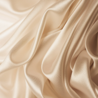 Smooth folds of luxurious cream-colored silk fabric create elegant waves and curves against a neutral background.