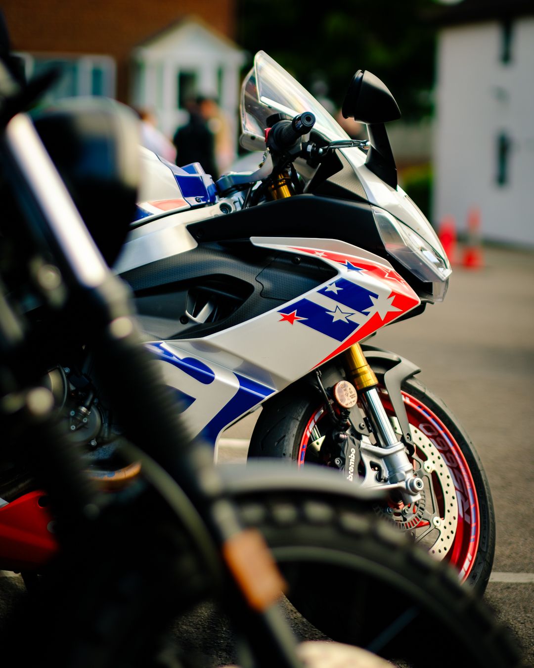 Close-up of a white and red sport motorcycle showcasing sleek design details and chrome accents.