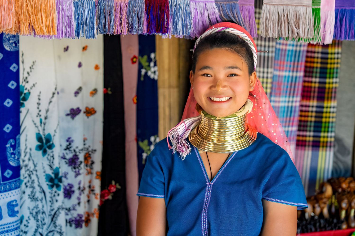 Colorful traditional textiles and clothing displayed in a local market.
