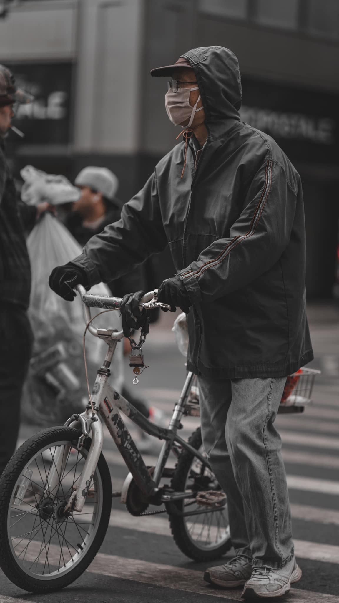 Children on bicycles in urban setting with monochromatic tones.