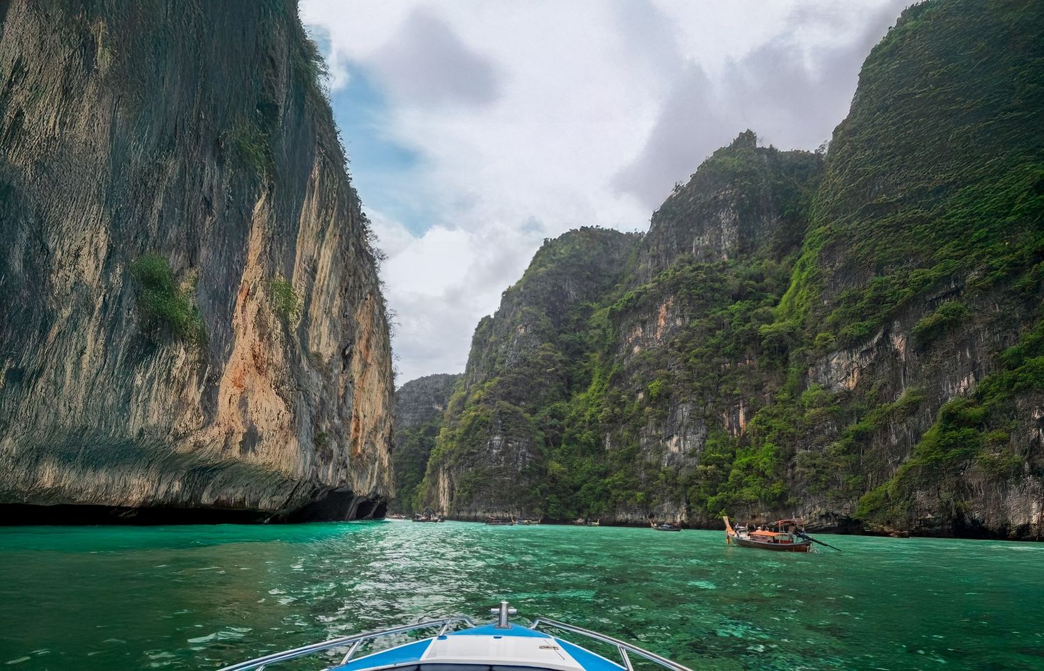 Stunning turquoise waters surrounded by towering limestone cliffs in a tropical lagoon.