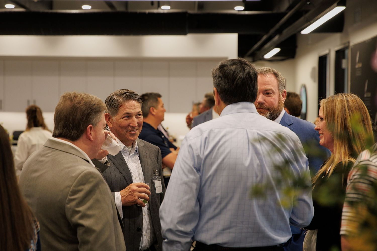 Corporate gathering with professionals networking in an indoor office environment.