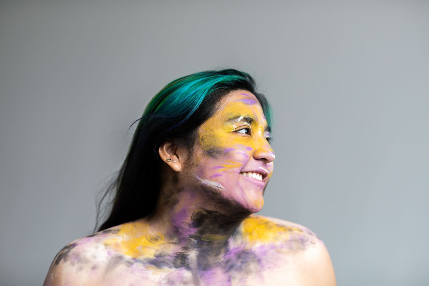 Close up of an individual painted black, yellow, purple and white.