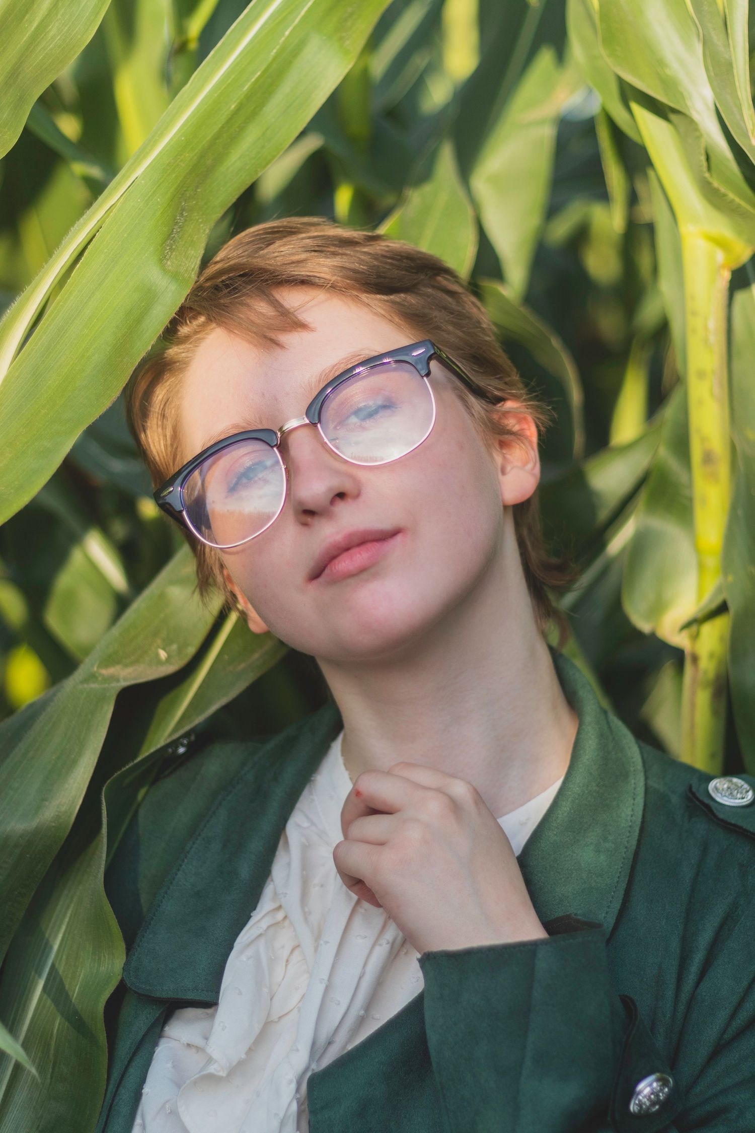 A high school senior poses in a corn maze.