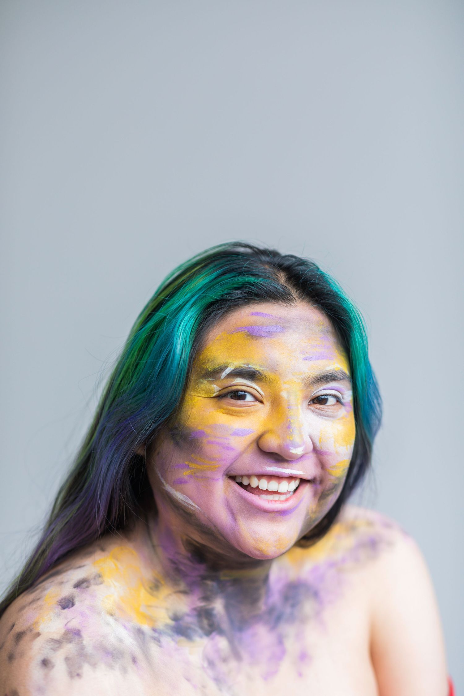 Close up of an individual painted black, yellow, purple and white.