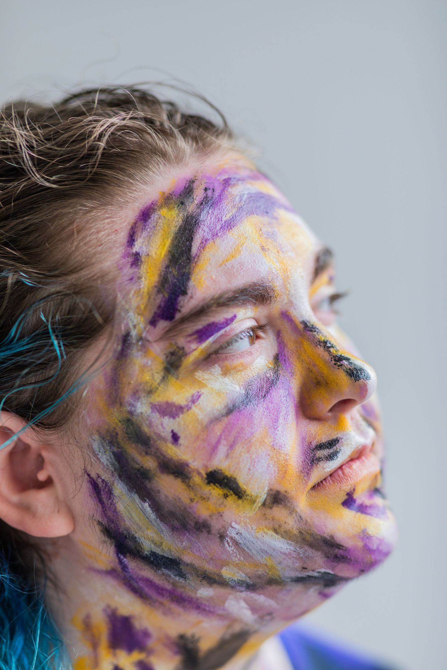 Close up of an individual painted black, yellow, purple and white.