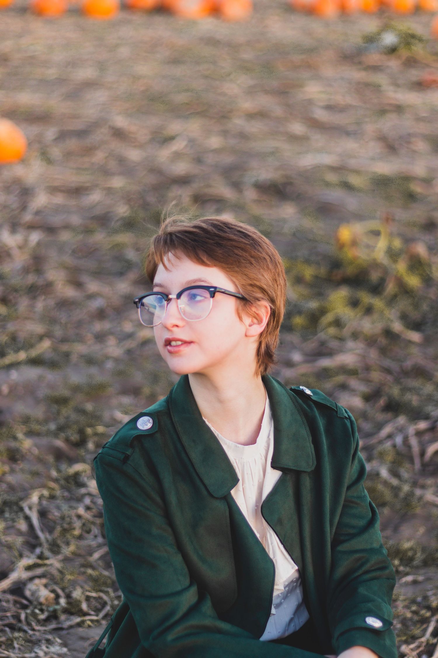 Senior poses fiercely in a pumpkin patch.