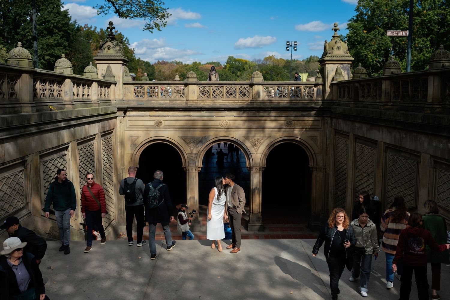 Wide view of a historic stone terrace with visitors in Central Park.