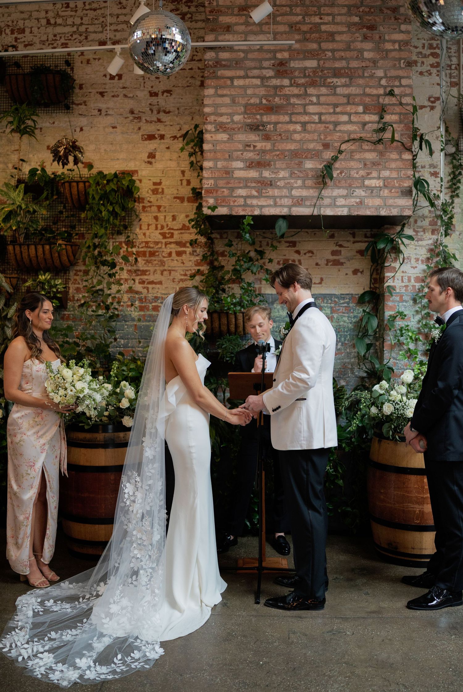 Wedding ceremony sequence showing special moments against a rustic brick wall with wine barrels and floral decor.