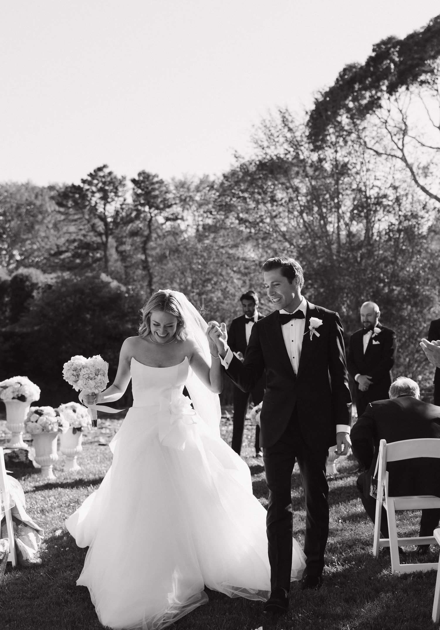 A celebratory moment captured during an outdoor garden wedding ceremony.
