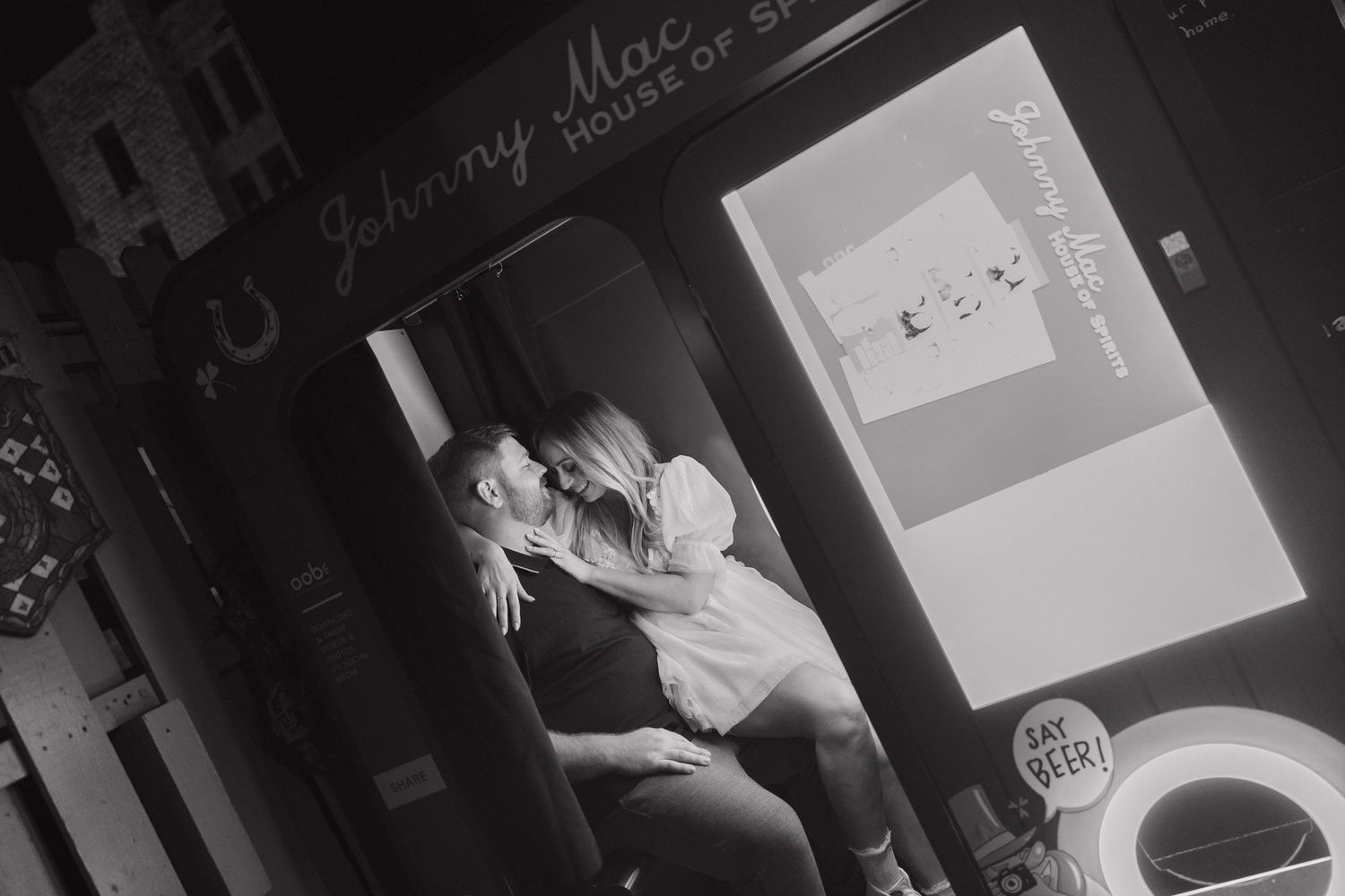 A cozy black and white scene showing someone relaxing in a dimly lit room with vintage decor.