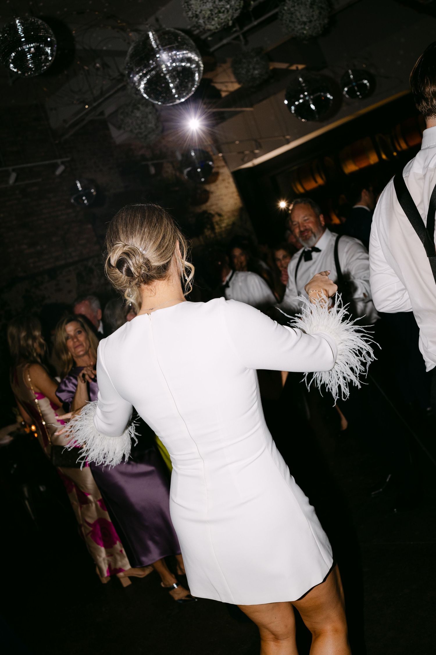 A sequence of dance floor photos showing someone in white clothing dancing energetically at a nightclub party.