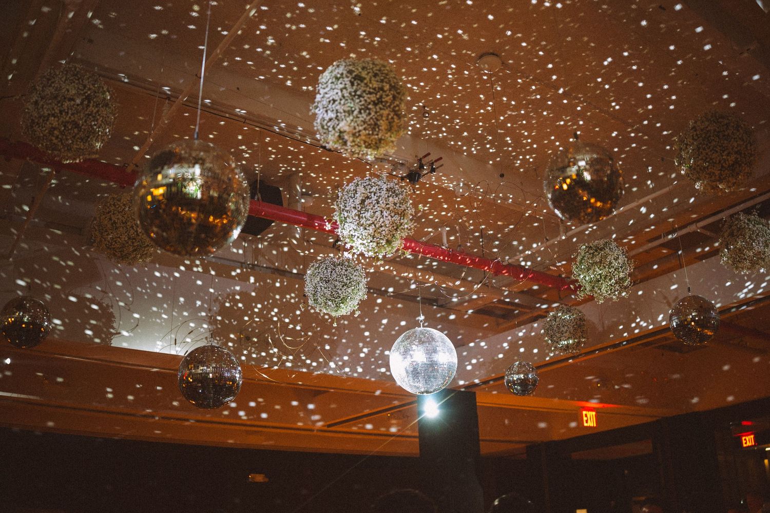 Glittering disco ball ceiling creating sparkling effects at wedding reception venue.
