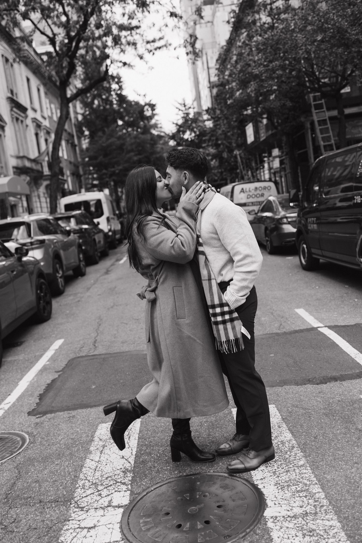 A romantic black and white photo sequence showing a couple embracing and dancing on a city street.