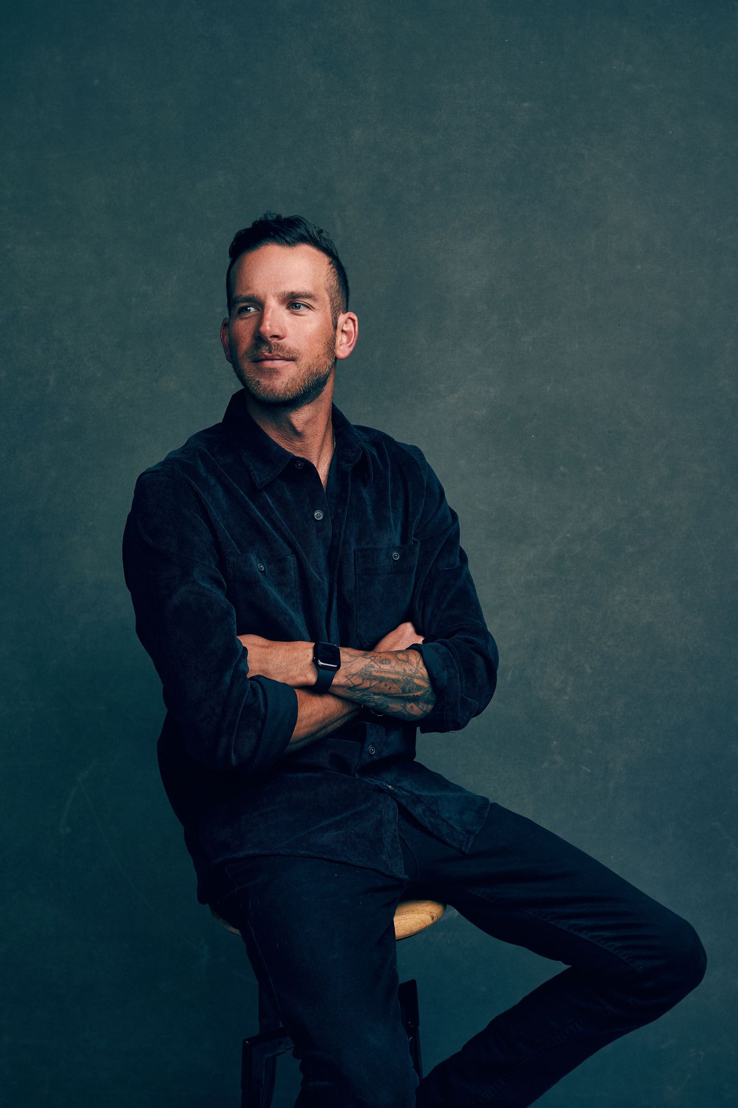 Professional studio portrait with moody lighting and contemporary styling.