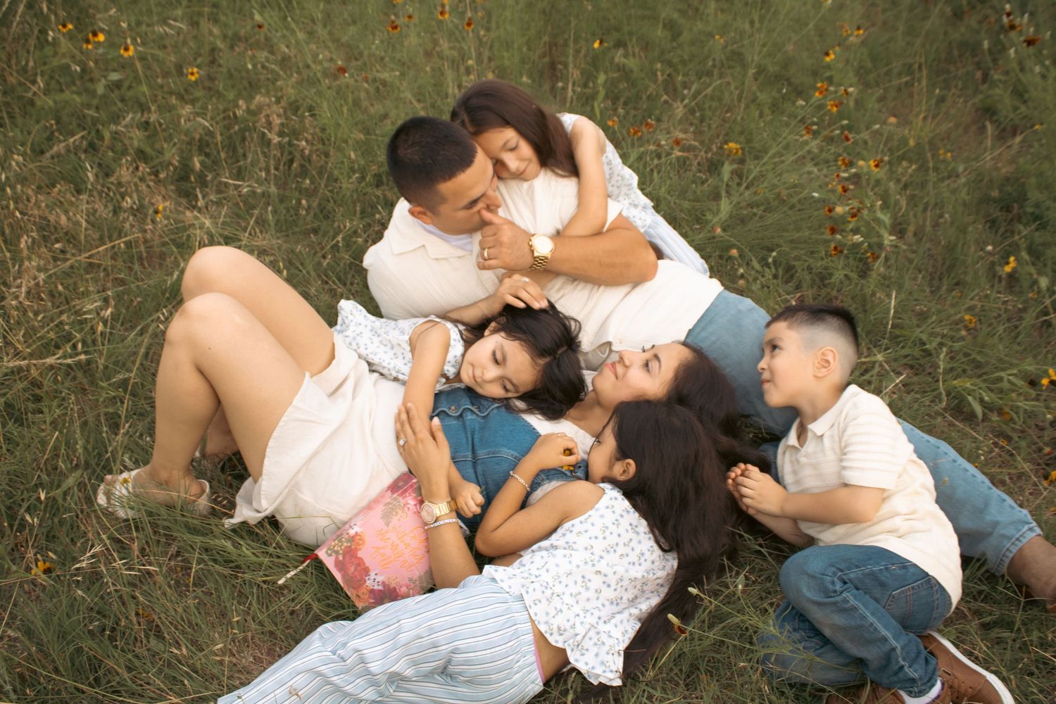 family lying in grass