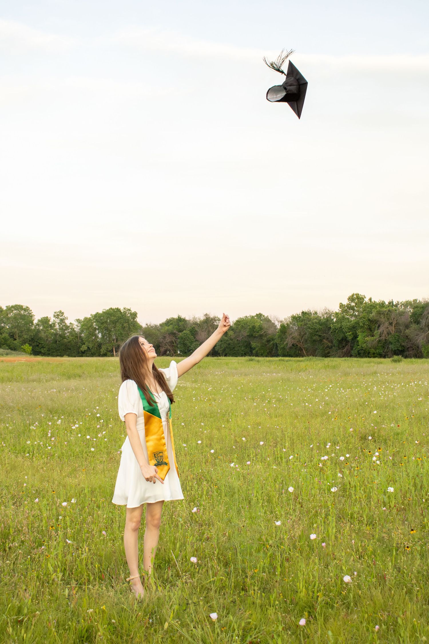 female grad throwing her cap