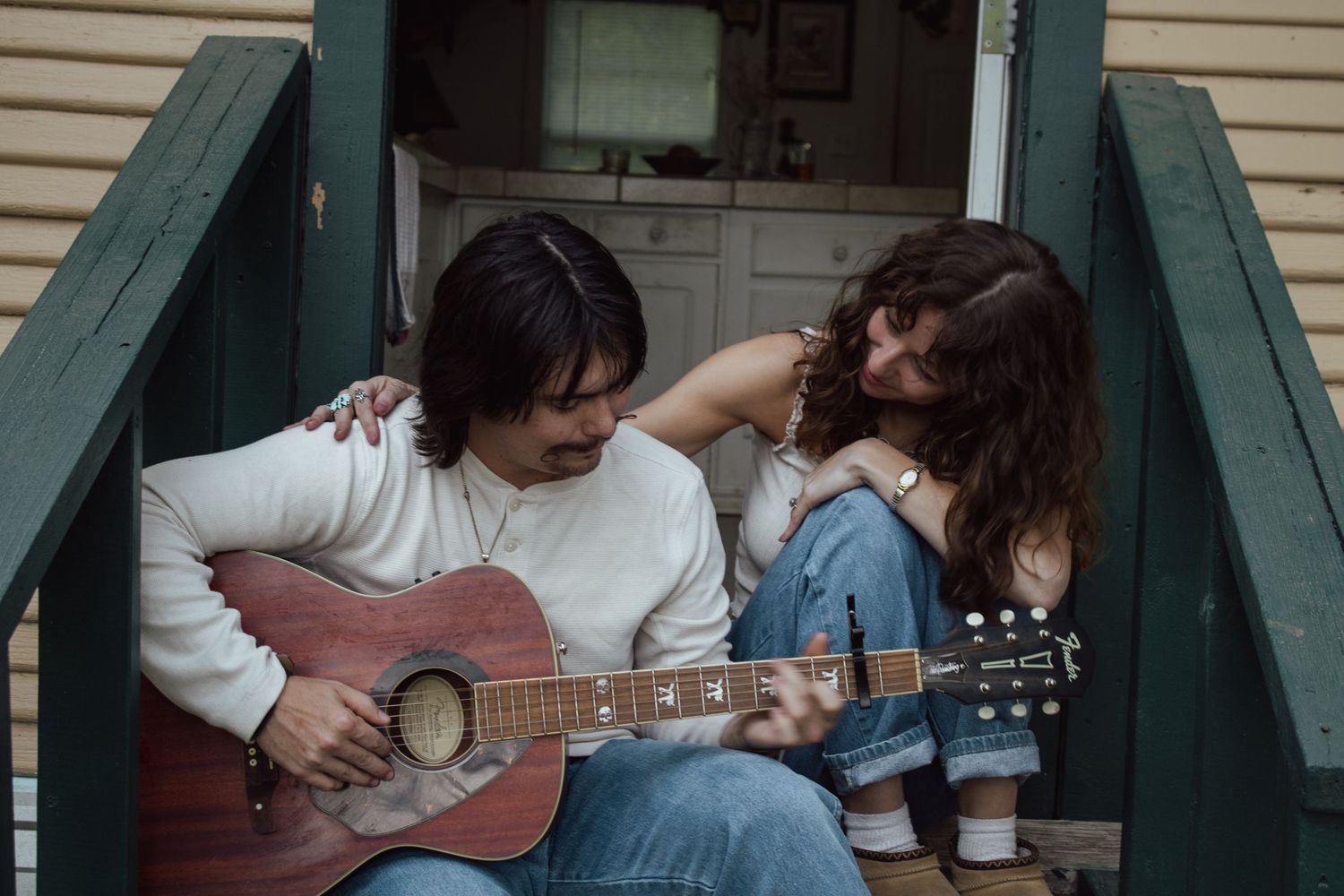 couple playing guitar together