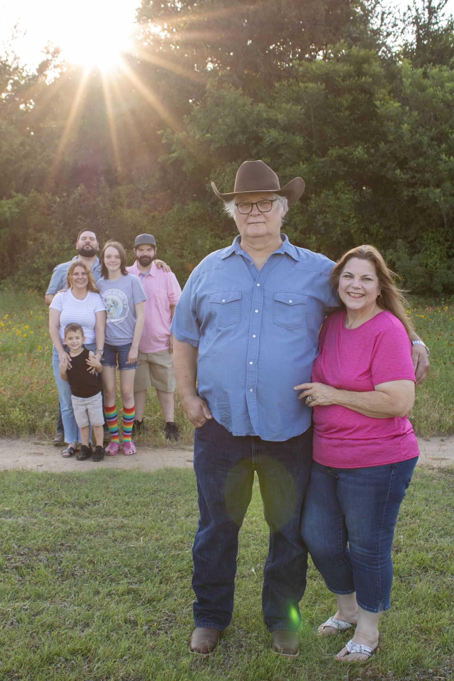 family with parents in front and rest of family in background