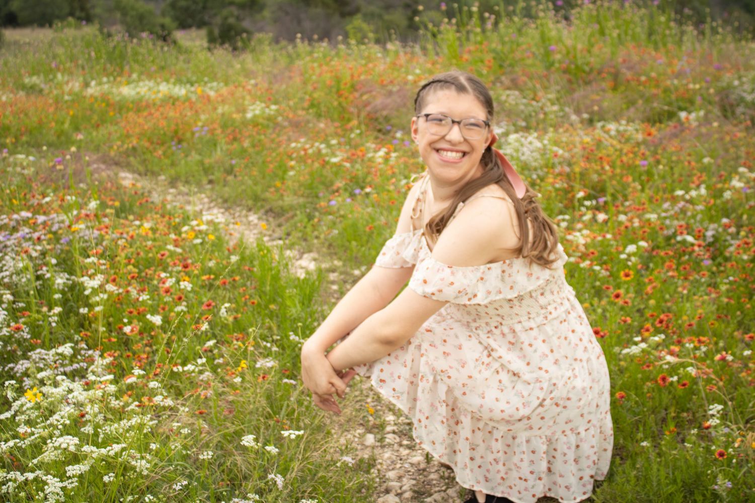 girl sitting in wildflowers