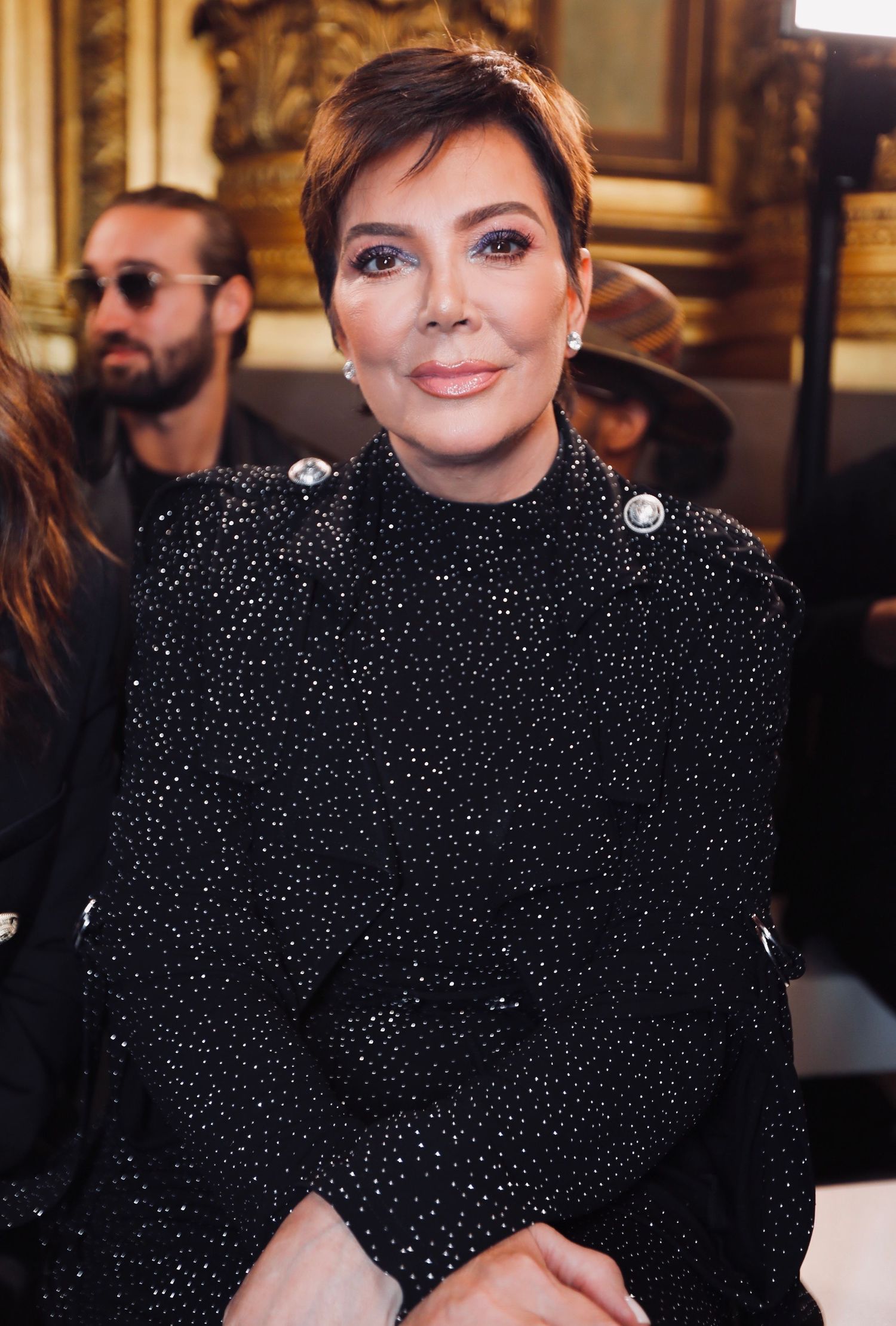 Glamorous shot of someone wearing a sparkly black top at a formal event.