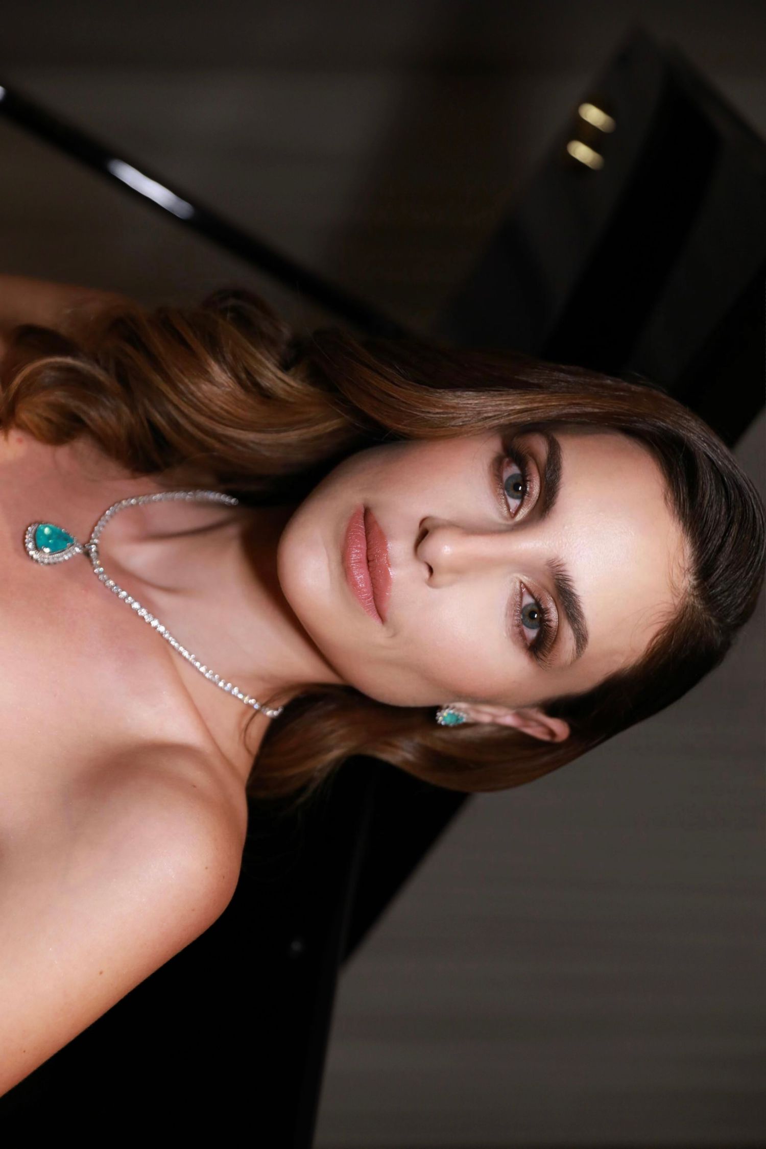 Glamour portrait featuring turquoise and diamond jewelry with soft lighting.