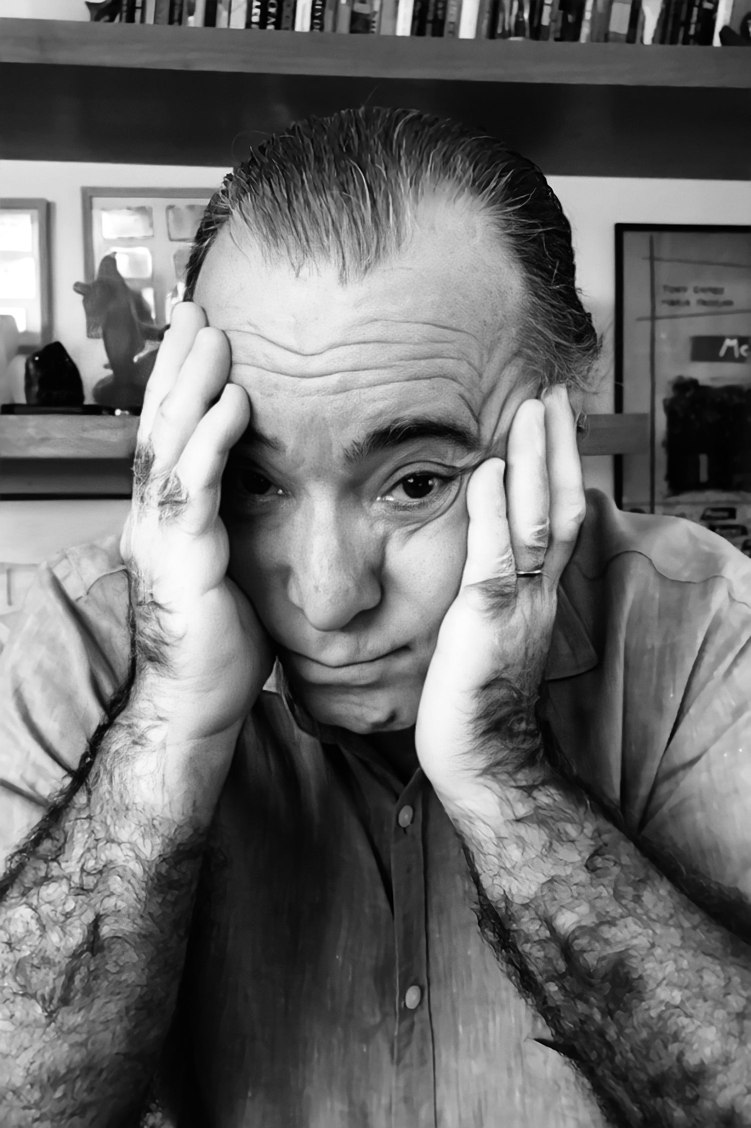 TONY RAMOS A black and white photograph of someone resting their head in their hands with a contemplative expression.