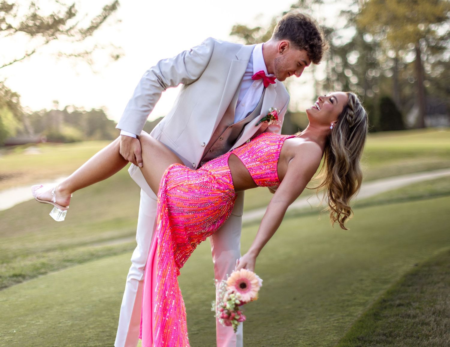 A man dipping his female prom date