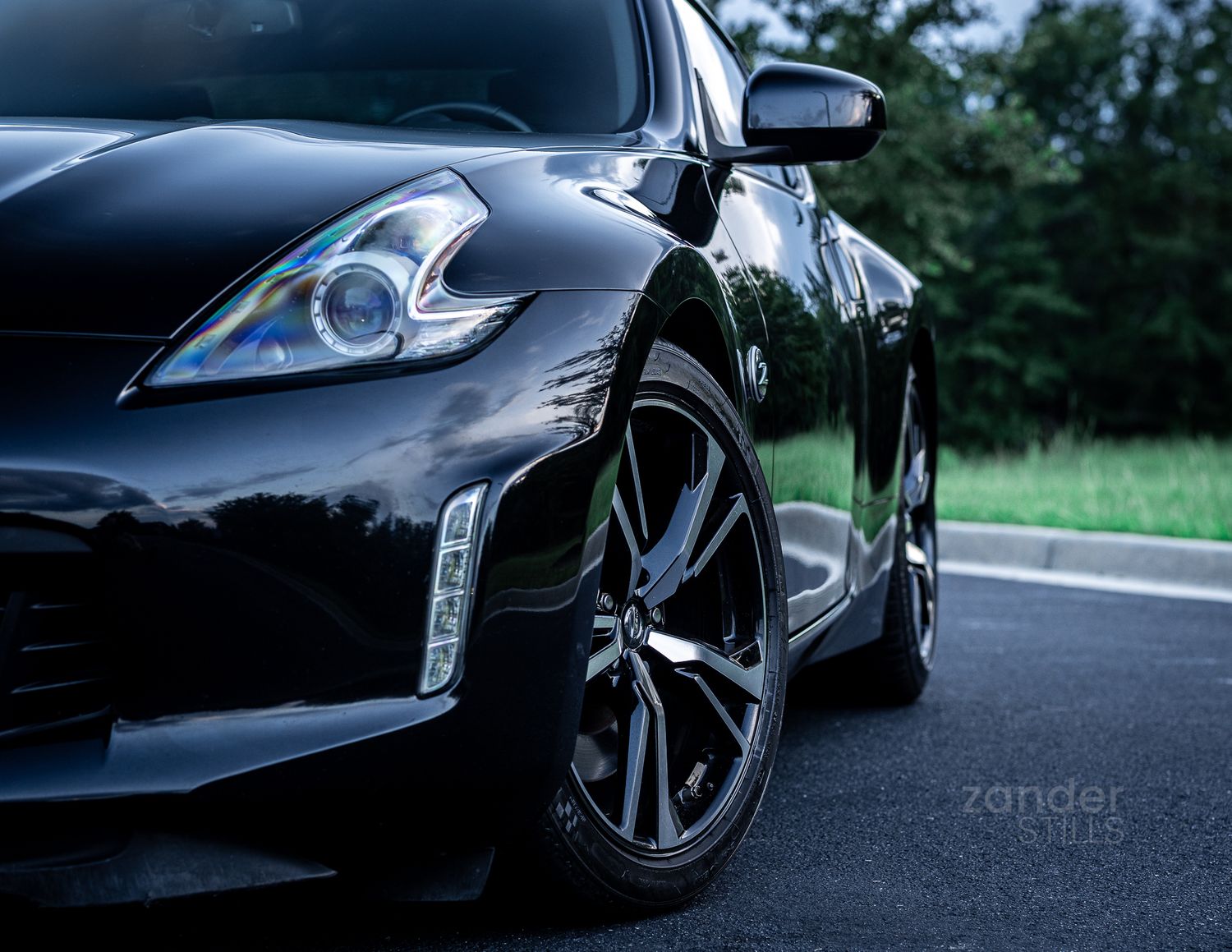 A focused image on the front corner of a black Nissan 370Z