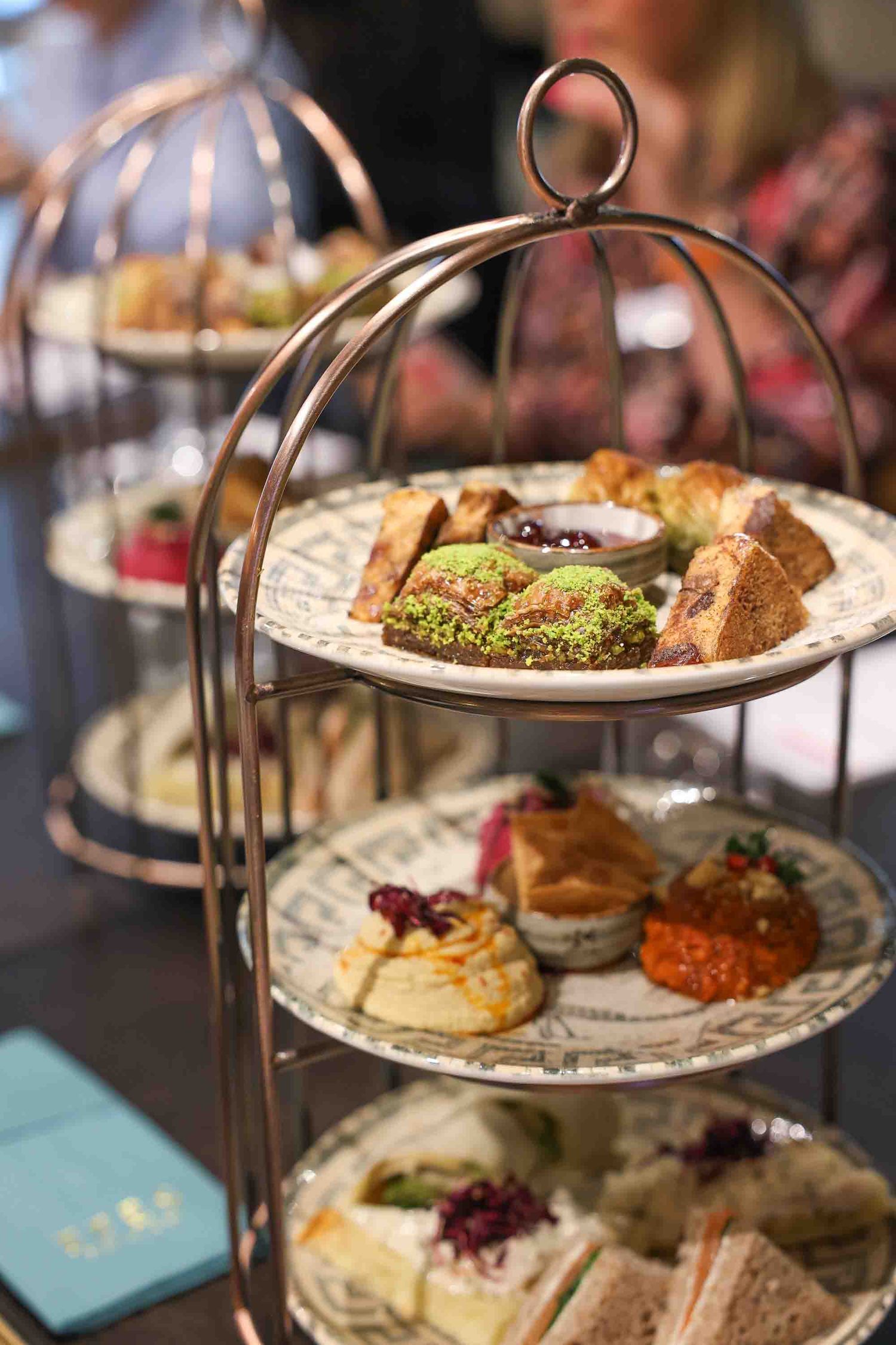 A close up of 3 tiers of afternoon tea